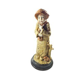 Figurine winter boy In coat scarf hat With Bird and tree